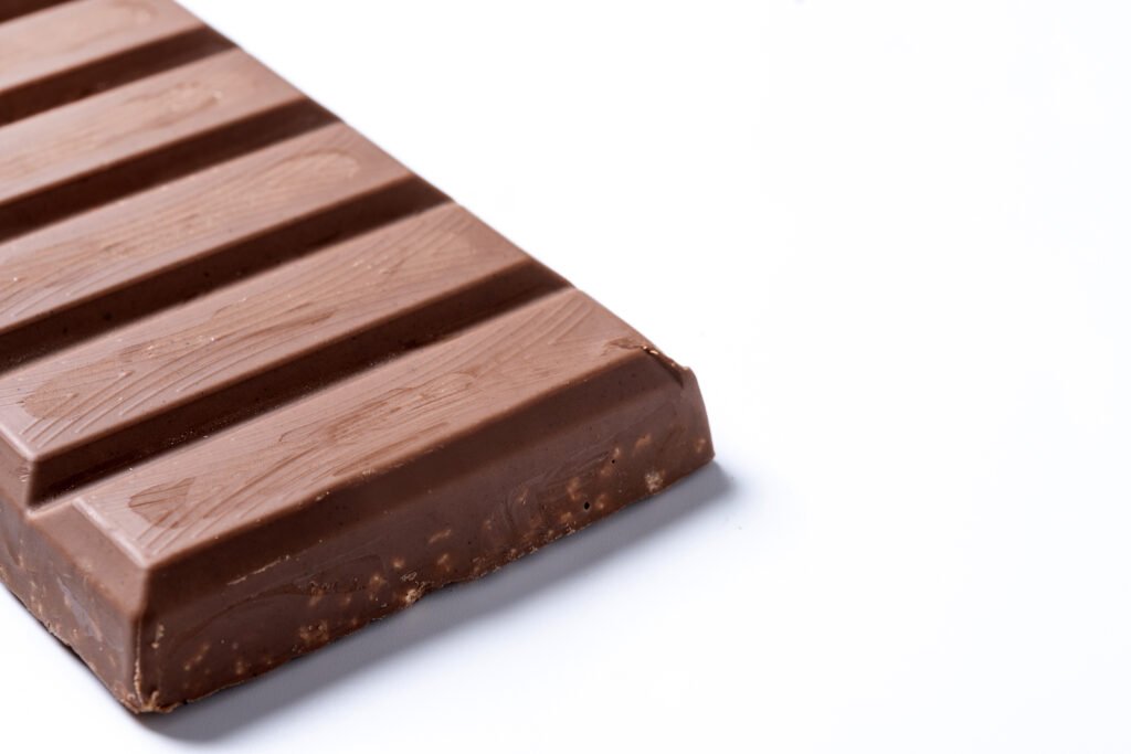 Creamy Milky Chocolate Bar unwrapped showing smooth texture and delicious shine.