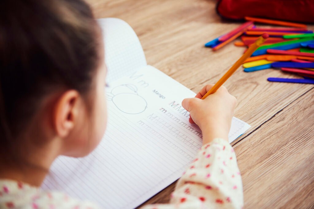 Preschooler practicing fine motor skills to prepare for writing