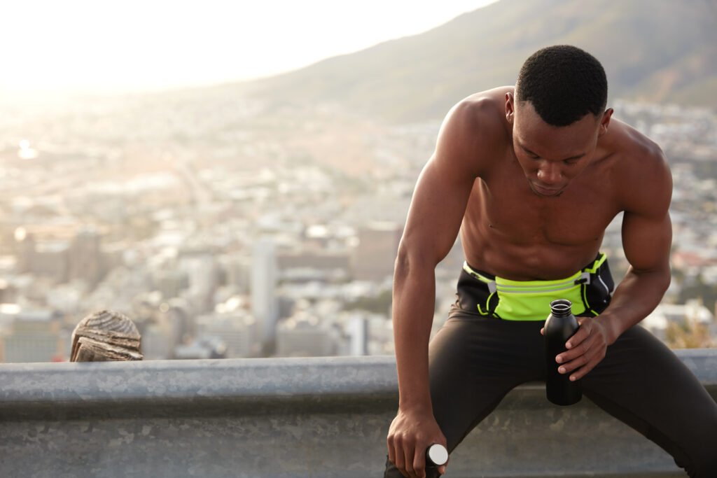 Athlete completing workout with NITRIC BOOST ULTRA supplement beside them