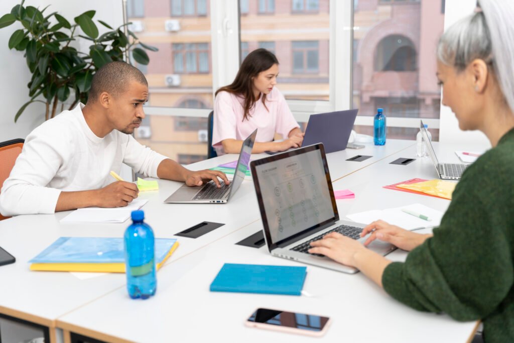 Remote startup team organizing SOPs and guides inside a cloud-based internal wiki platform.”