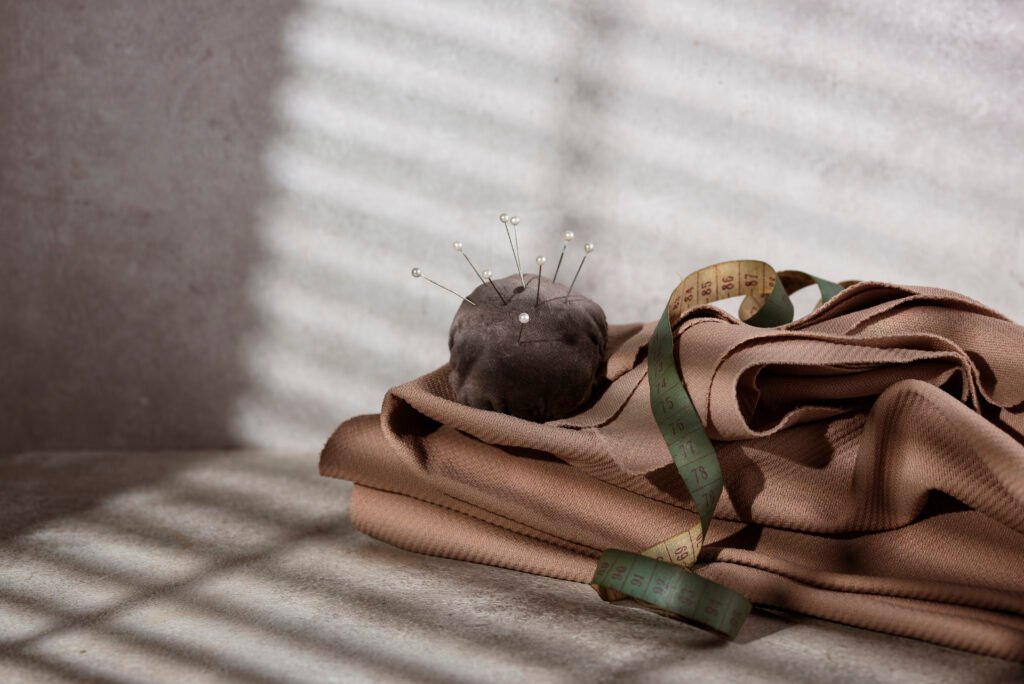 Collage of Abera clothing details – hidden buttons, smooth seams, and minimalist silhouettes